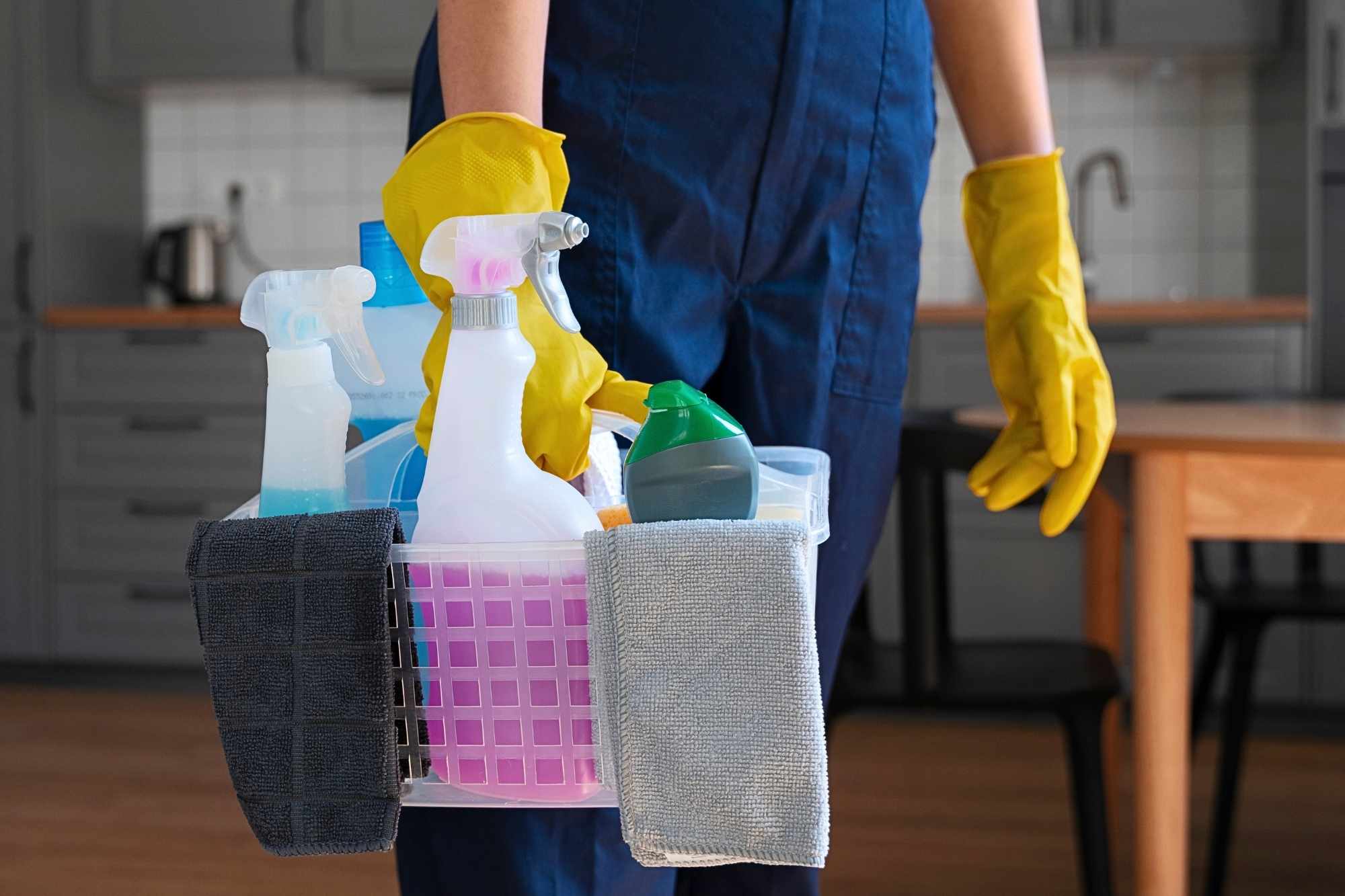 Professional cleaner holding a bucket of supplies for move-in and move-out cleaning services